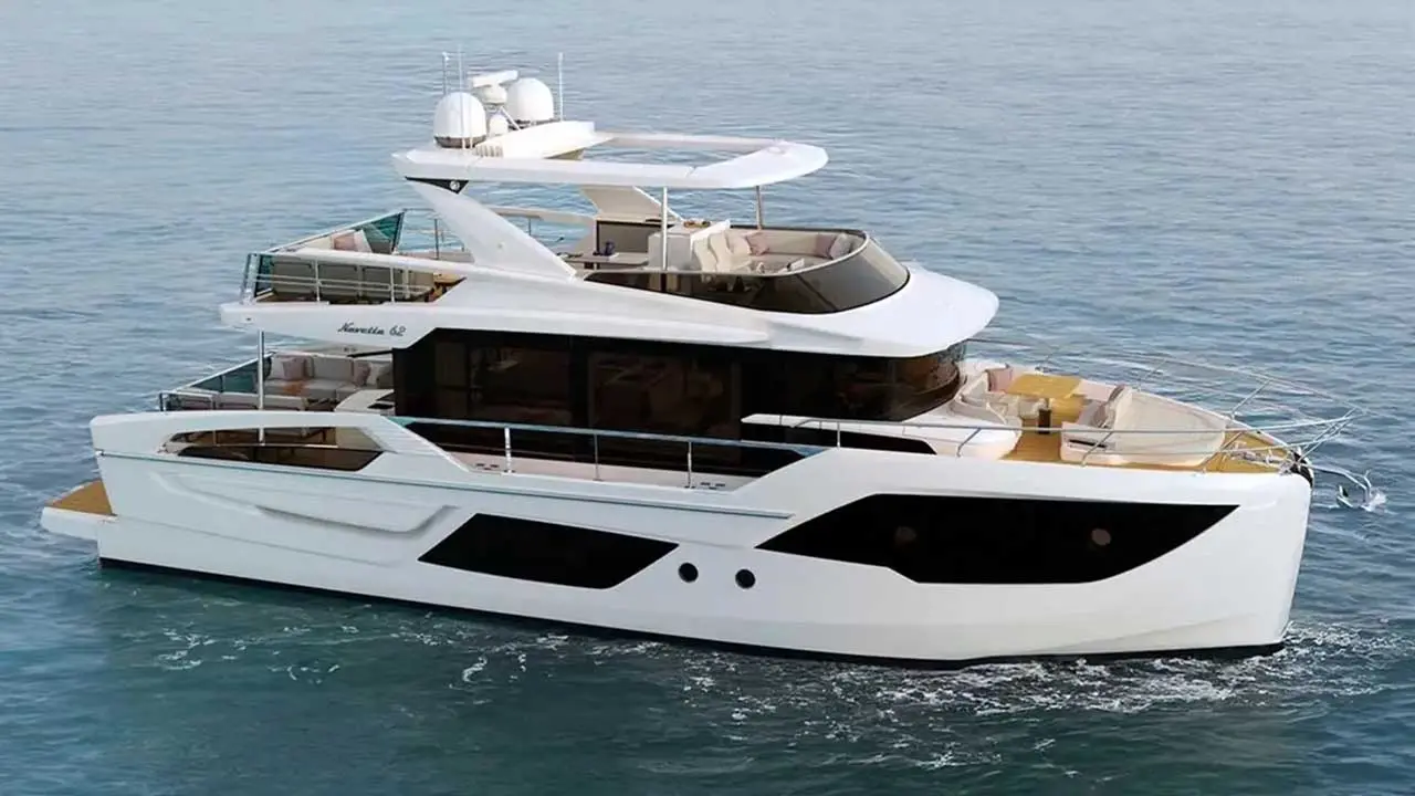 White luxury motor yacht marked “Navetta 68” cruising on calm blue sea