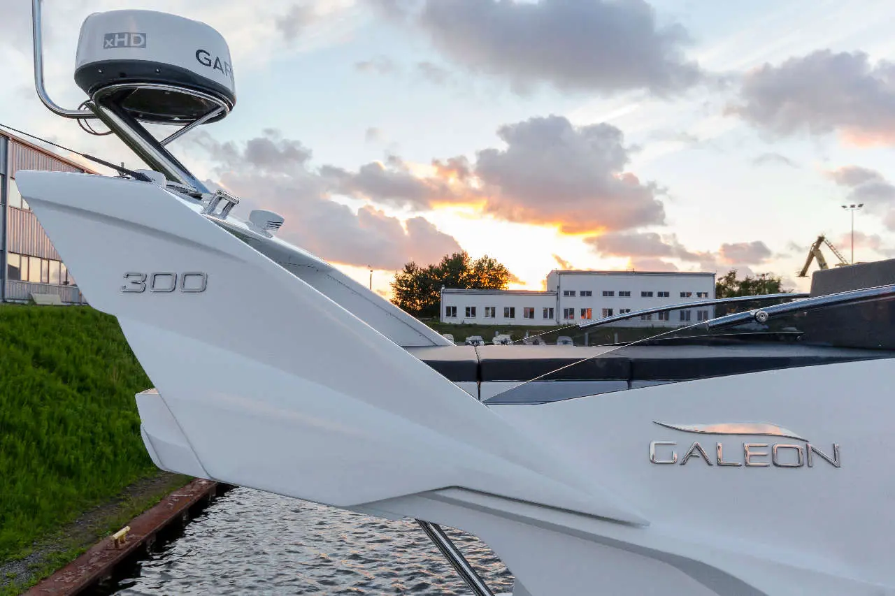 Galeon 300 motorboat with a Garmin xHD radar at sunset, showcasing sleek design and tranquil marina surroundings.