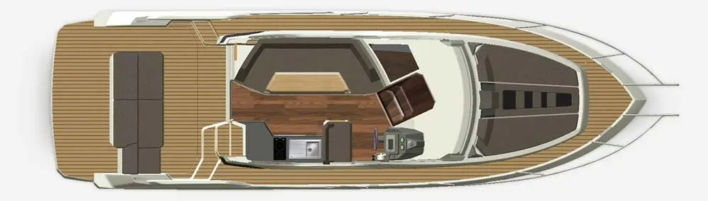 Top view of a luxury boat interior featuring a dining area, seating, and a compact kitchen with appliances on wooden decking.