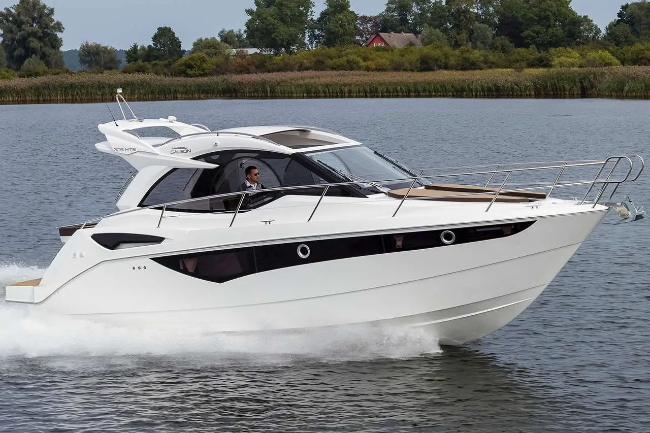 A sleek white motor yacht, labelled 
