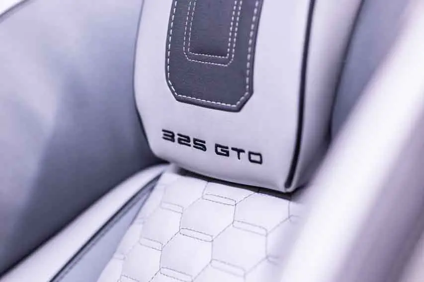 Close-up of a car seat headrest featuring the embossed text 