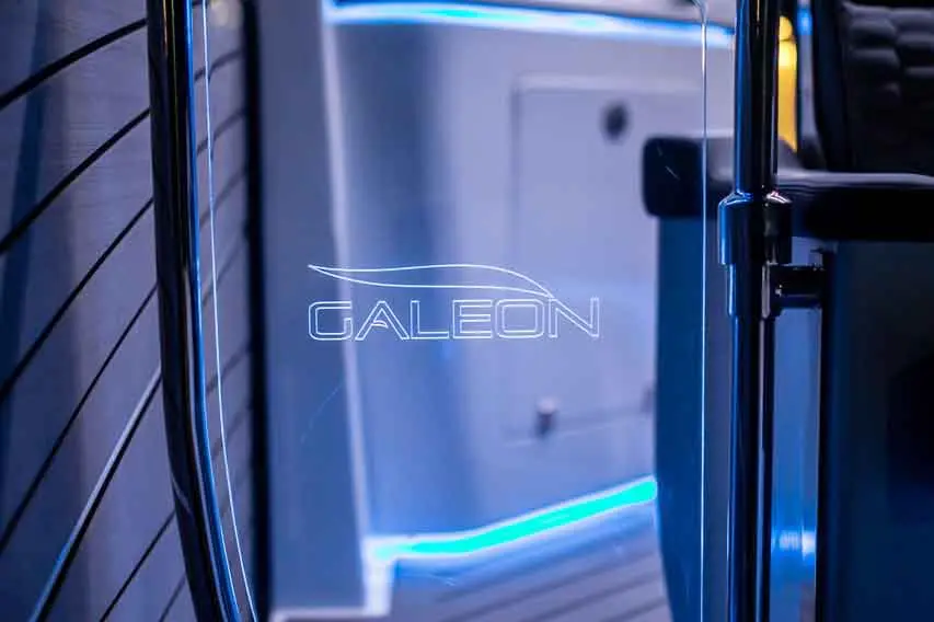 Galeon logo illuminated on a sleek yacht interior, featuring modern design and blue LED lighting accents.