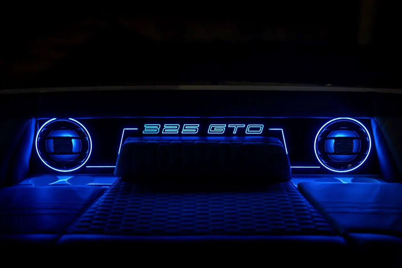 Interior view of a car dashboard with illuminated blue accents and 