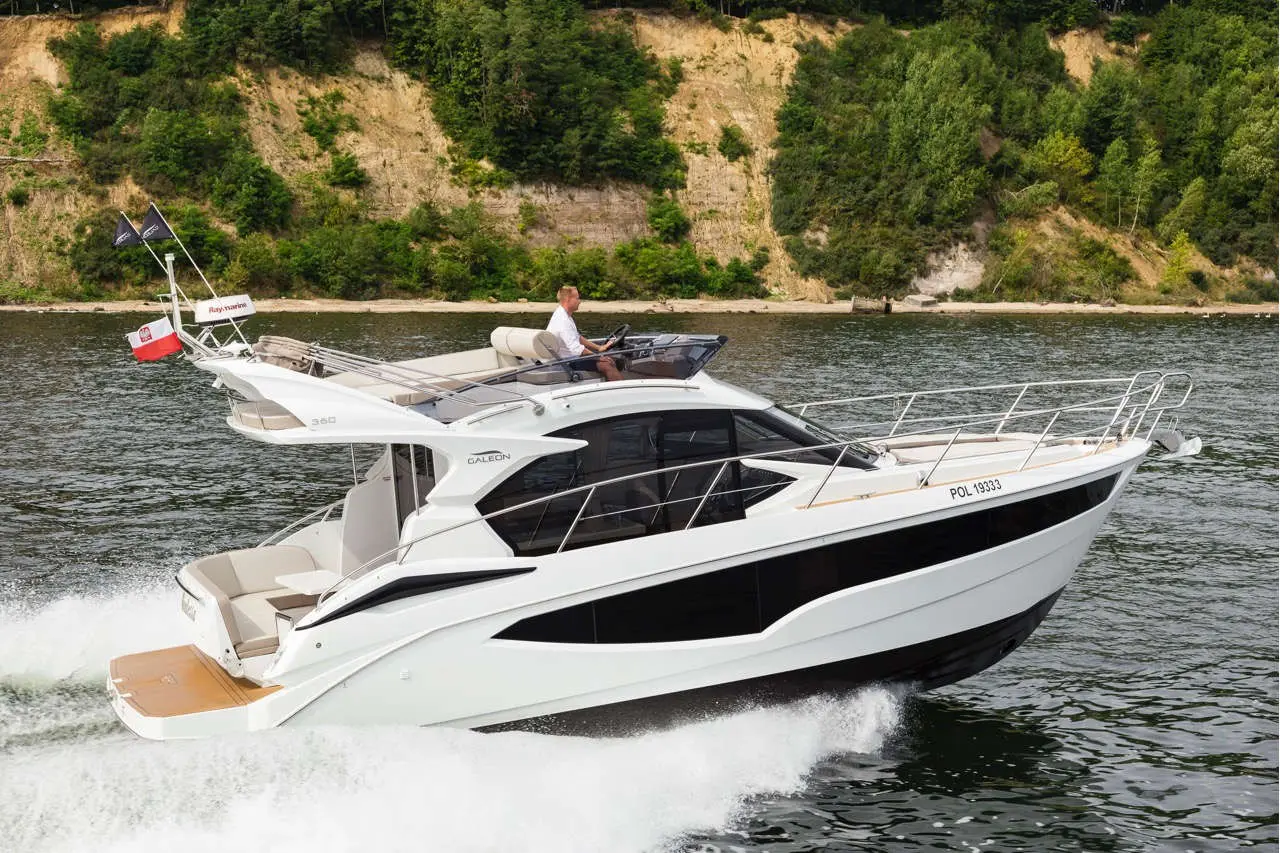 A sleek white yacht, labeled 