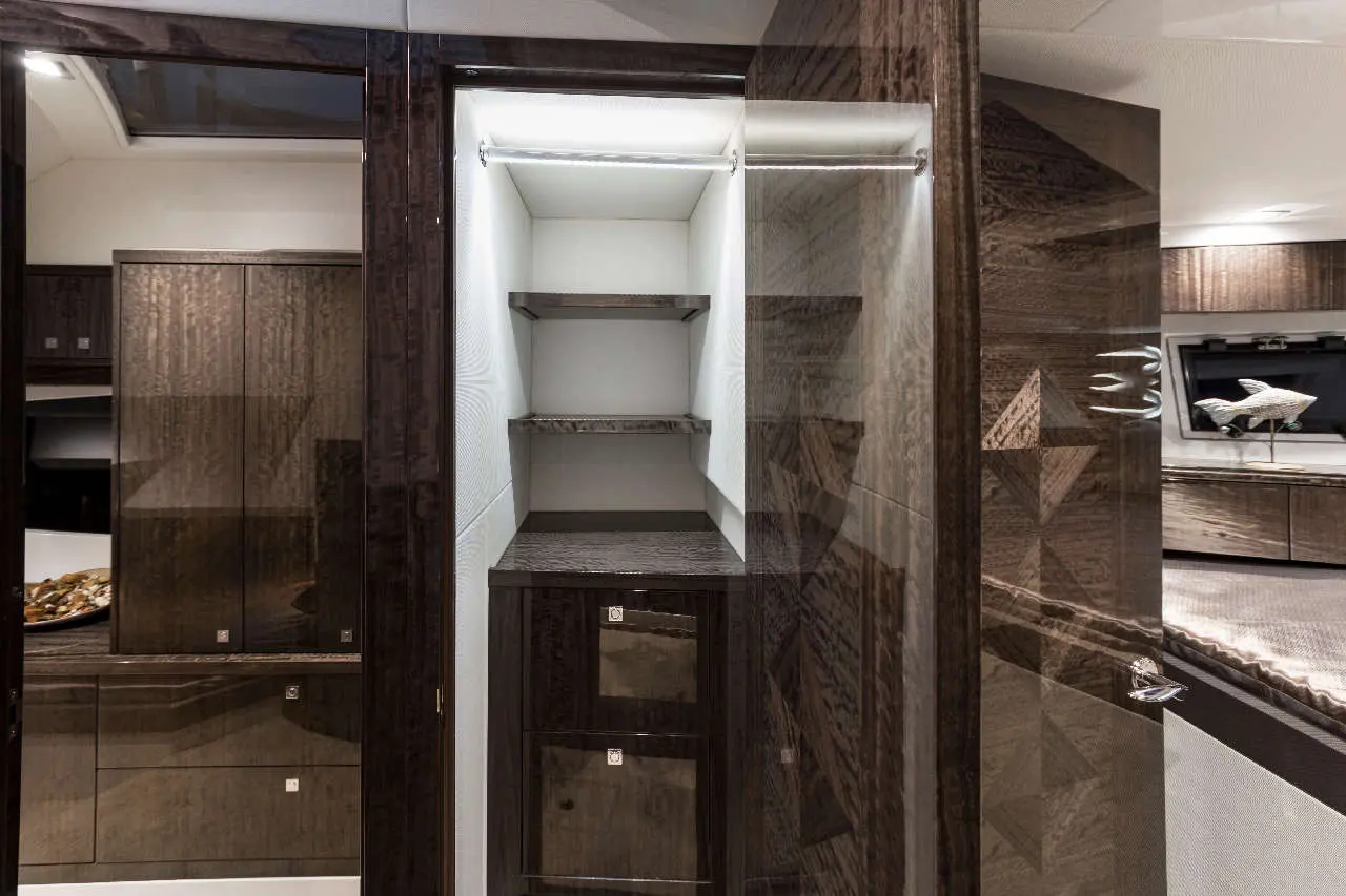 A sleek, modern wardrobe with wood finish and three shelves, featuring a clean, organized interior in a stylish room.