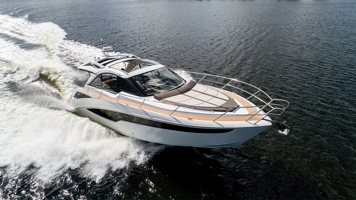 Sleek luxury boat navigating through water, leaving a frothy wake on a sunny day. Perfect for marine enthusiasts.