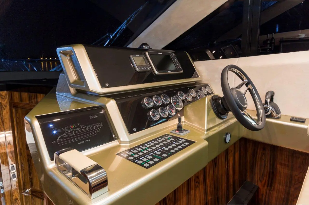 Luxurious yacht cockpit featuring a sleek dashboard, multiple gauges, controls, and the 