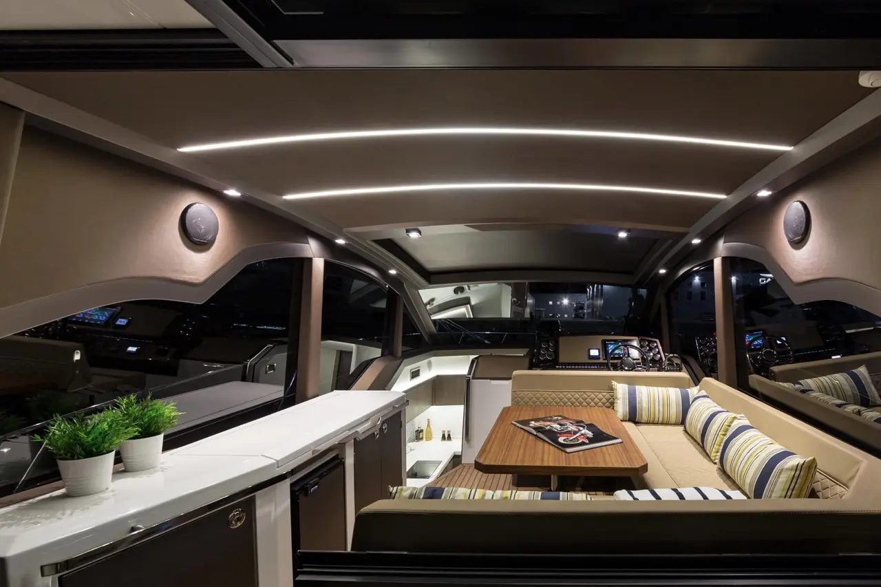 Luxurious yacht interior featuring a seating area, modern decor, ambient lighting, and nautical-themed decor on the table.