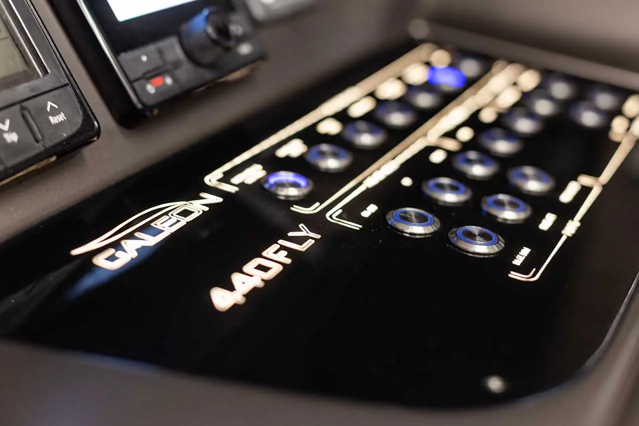 Control panel of a Cal leon 440FLY yacht, featuring illuminated buttons and digital displays for navigation and operation.