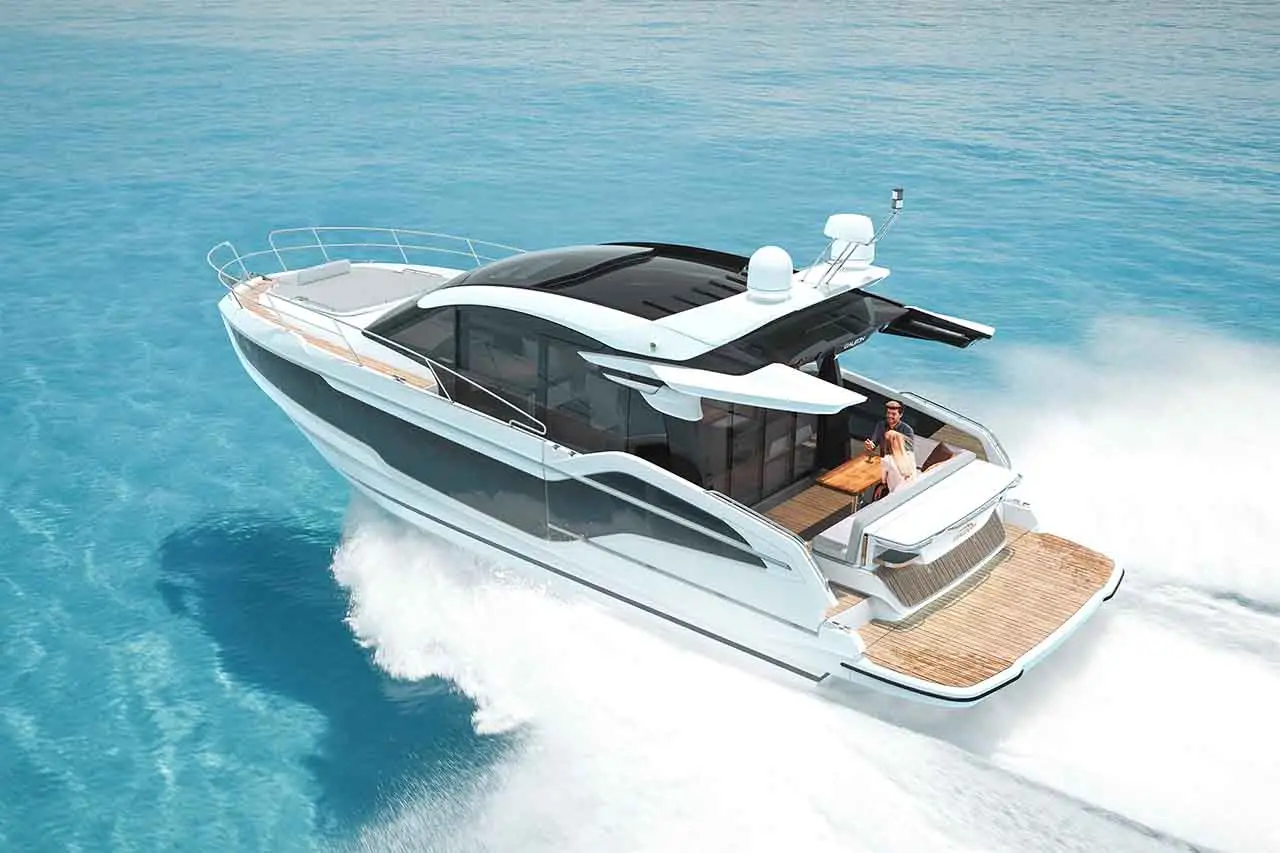 Luxury motor yacht cruising on clear blue waters, with a man and woman enjoying a meal on the deck.