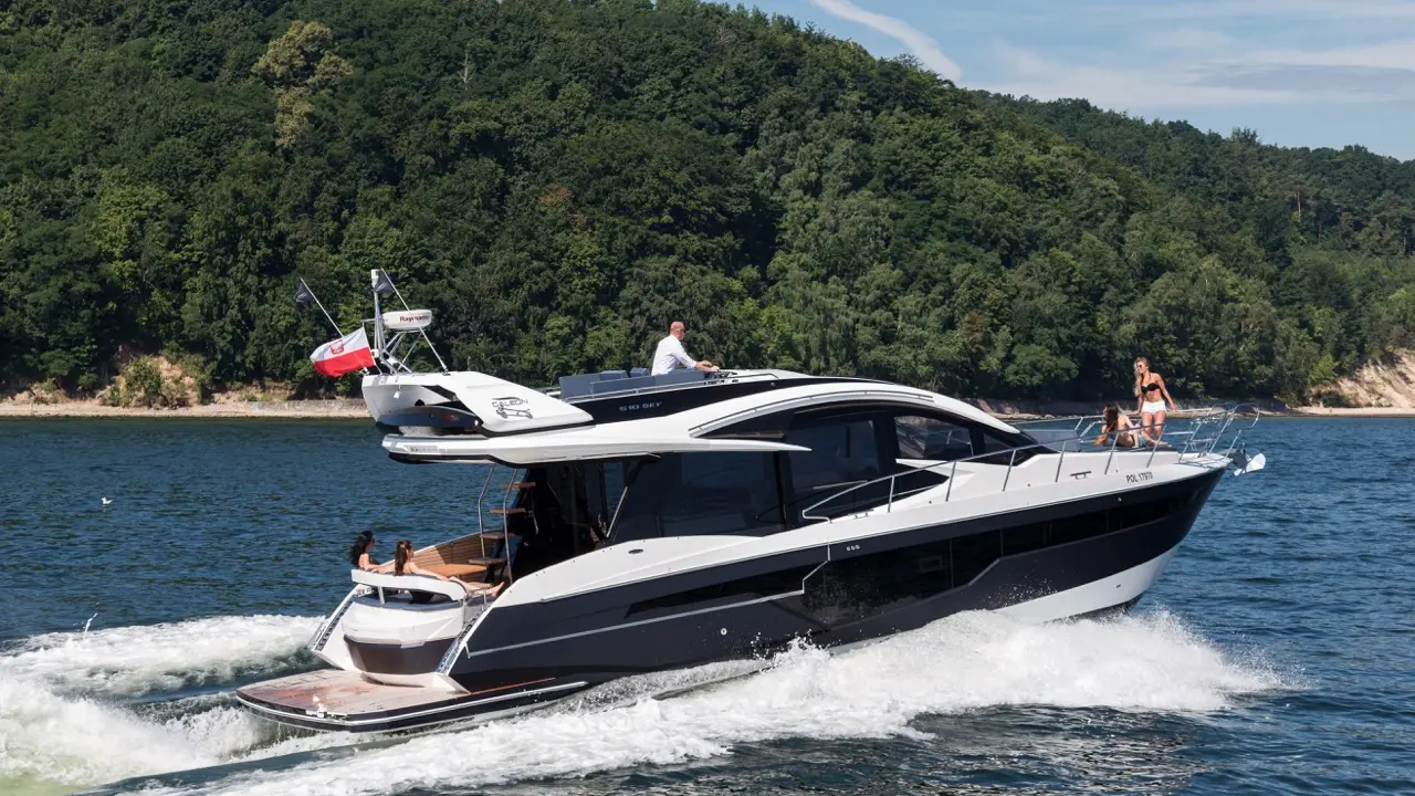 Luxury yacht cruising on a lake, with a man steering and two women enjoying the sun on the deck, surrounded by greenery.