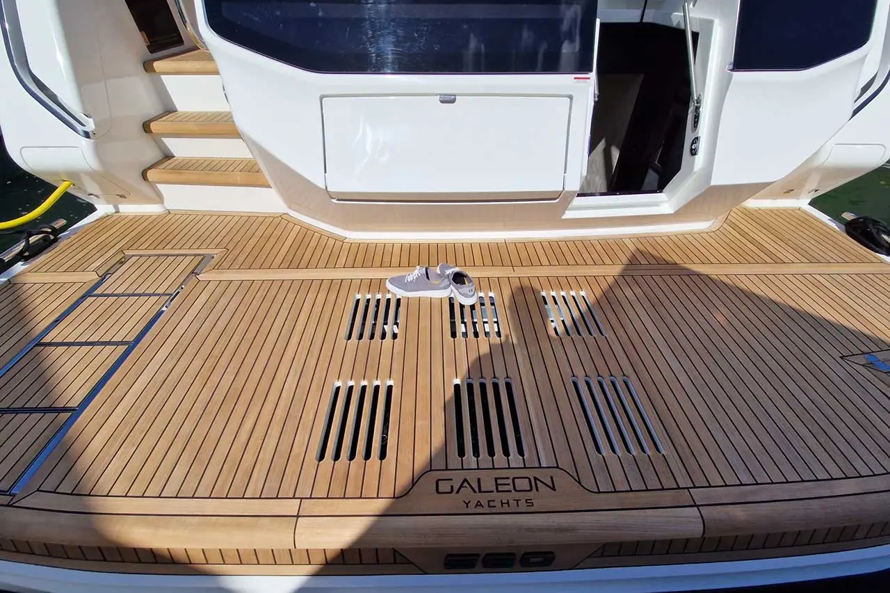 Wooden yacht deck with a pair of sneakers, featuring 