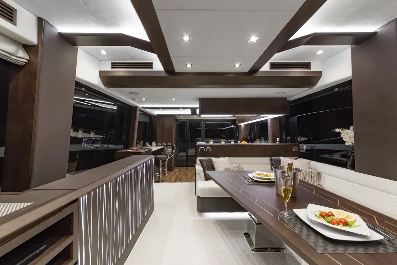 Luxurious yacht interior featuring a modern dining area, sleek bar, vibrant dishes, and elegant lighting.