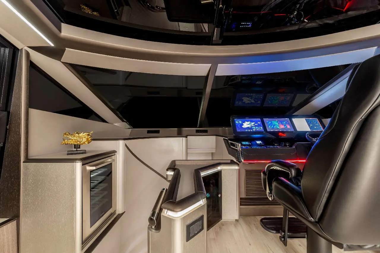 Luxury cockpit featuring multiple screens, a black chair, a gold dragon statue, and a sleek, modern design.