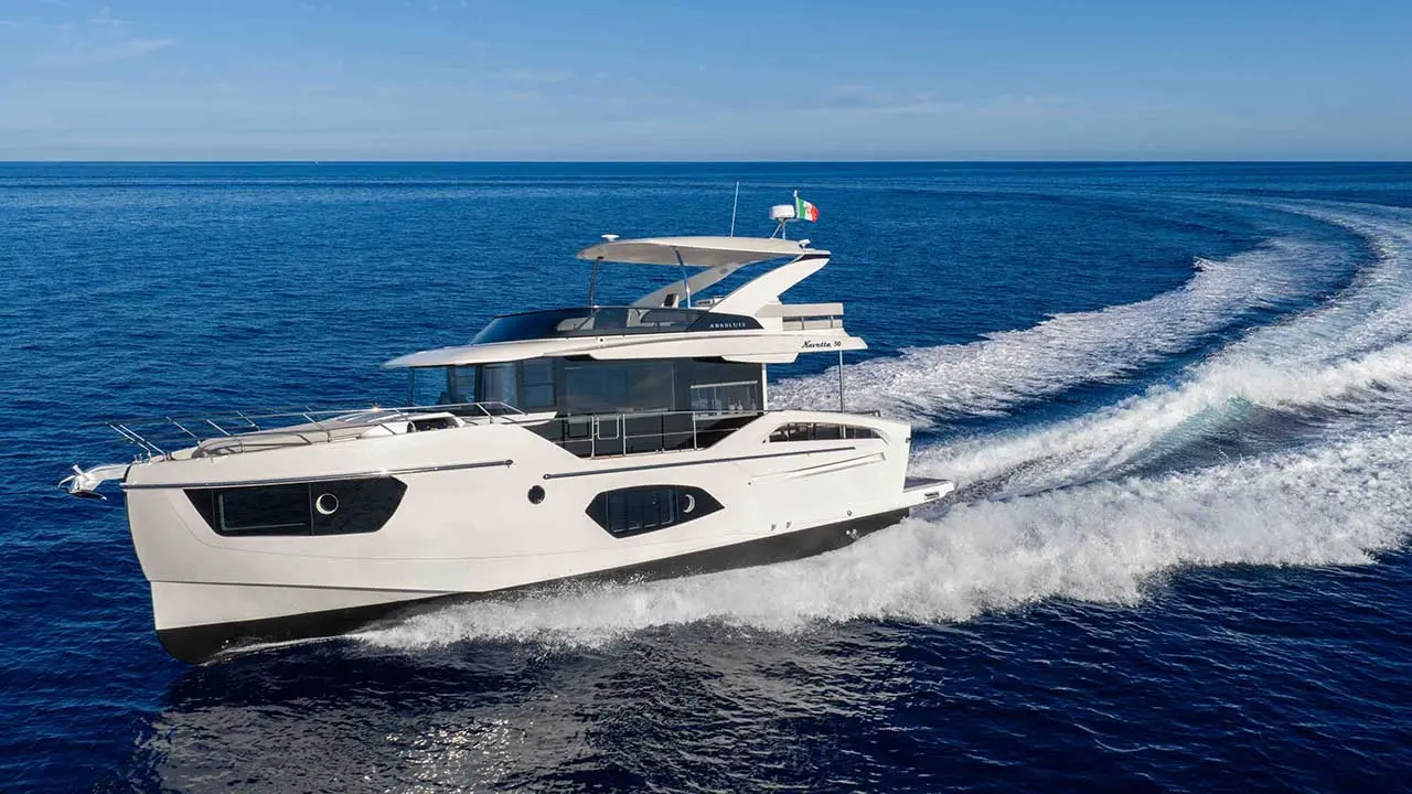 White Azimut Navetta 50 motor yacht cruising across deep blue sea, leaving a foamy wake