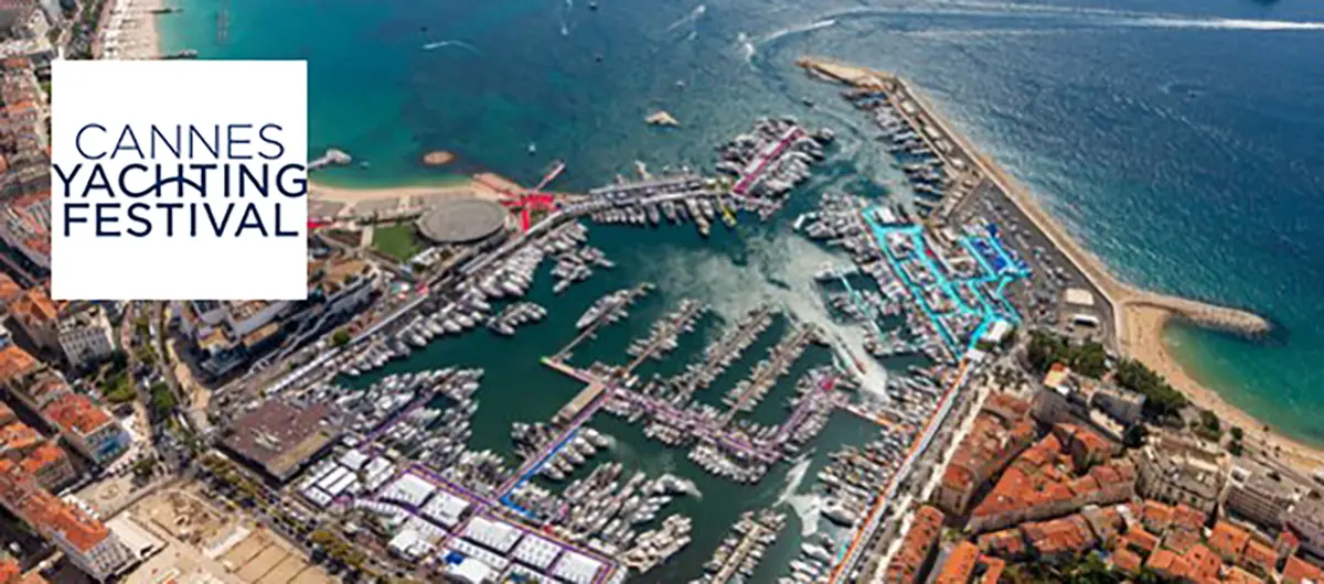 Aerial view of Cannes harbour during the Yachting Festival, showcasing numerous yachts and the waterfront.
