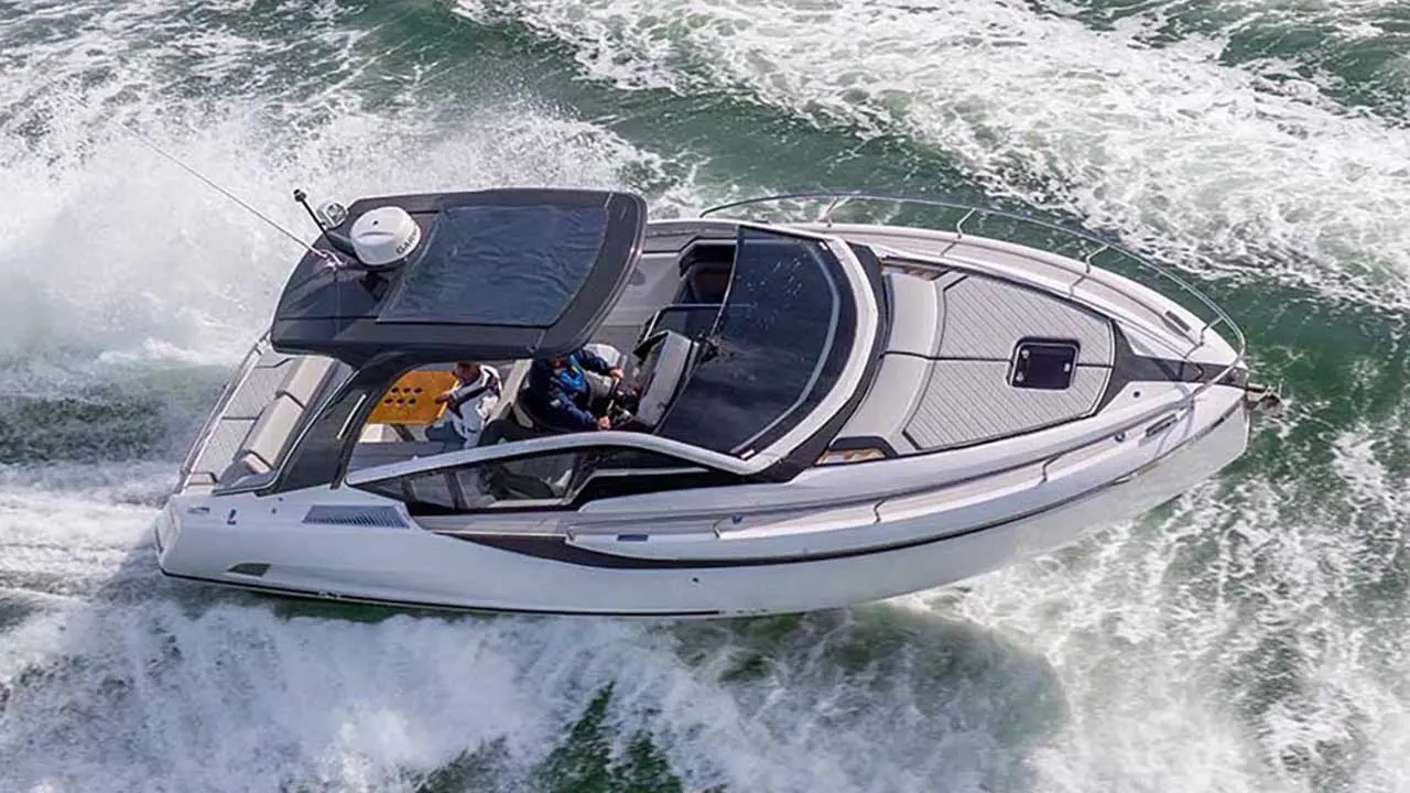 Modern white motorboat speeding across the sea, with passengers aboard and a foaming wake.