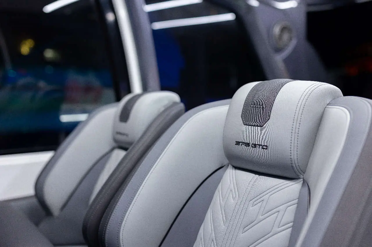 Grey car seats with modern design and patterned headrests featuring 