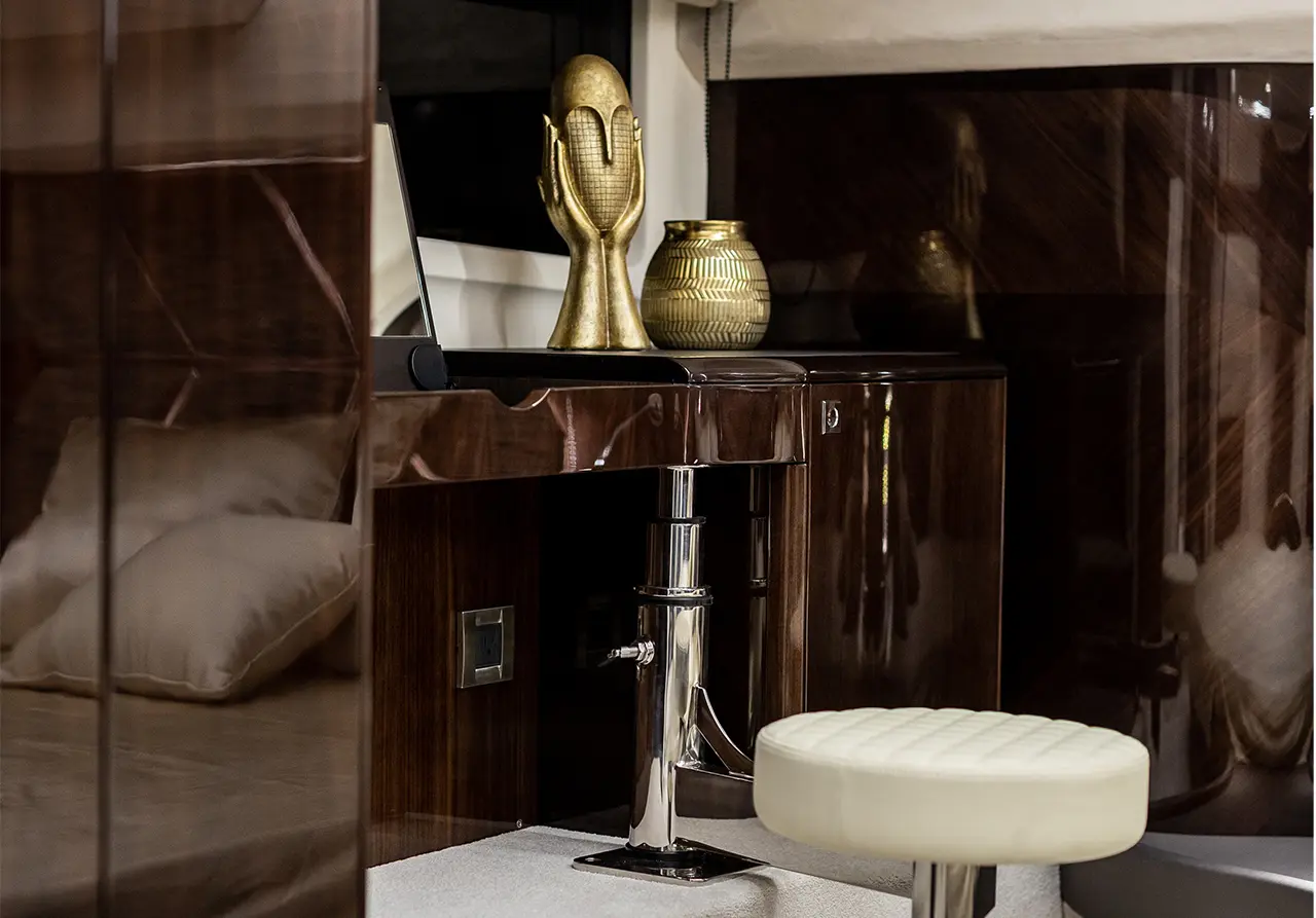 Stylish interior featuring a golden sculpture, decorative vase, and sleek furniture in a modern setting.