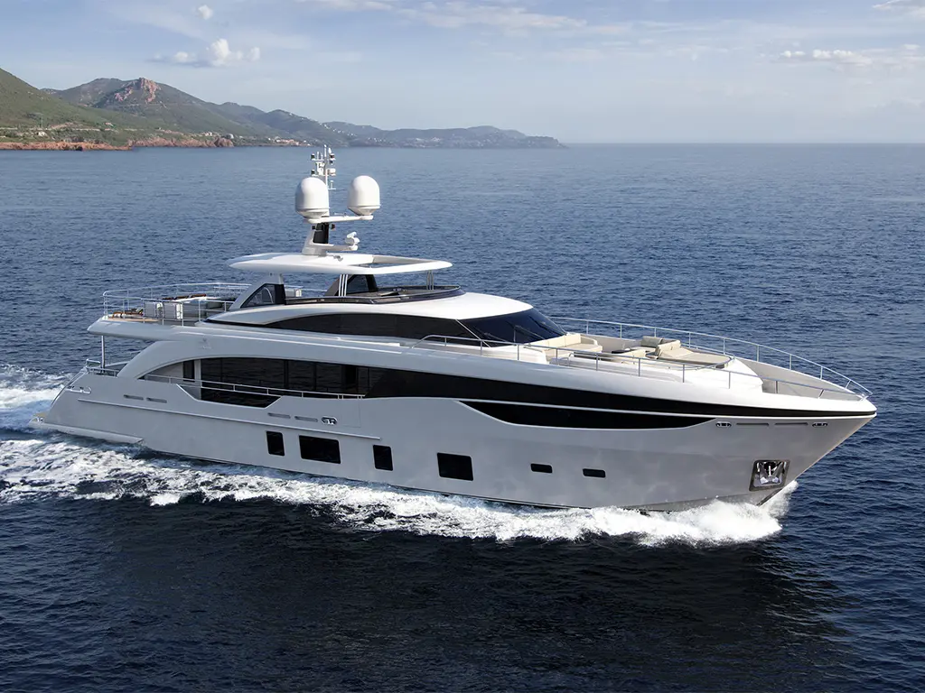 Luxury yacht cruising on calm waters, surrounded by hills and a clear sky. Ideal for upscale nautical adventures.