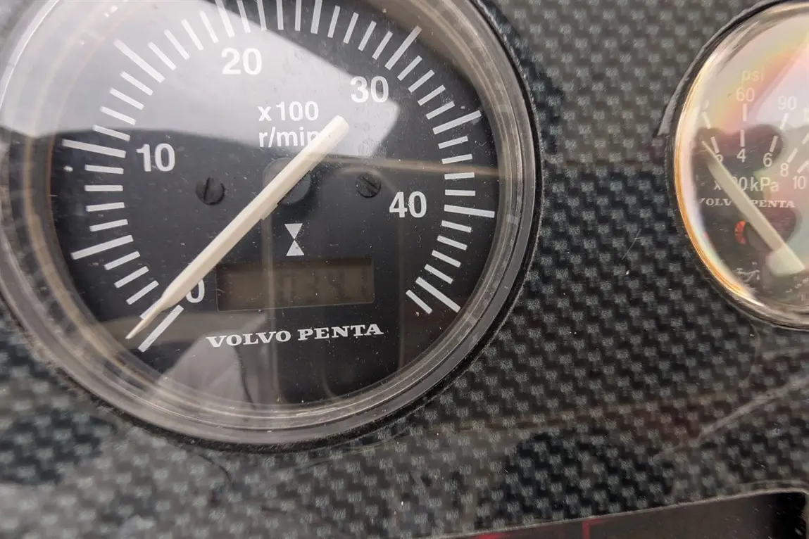 Volvo Penta gauge showing RPM marked at 0, with a carbon fibre background and an additional pressure gauge.