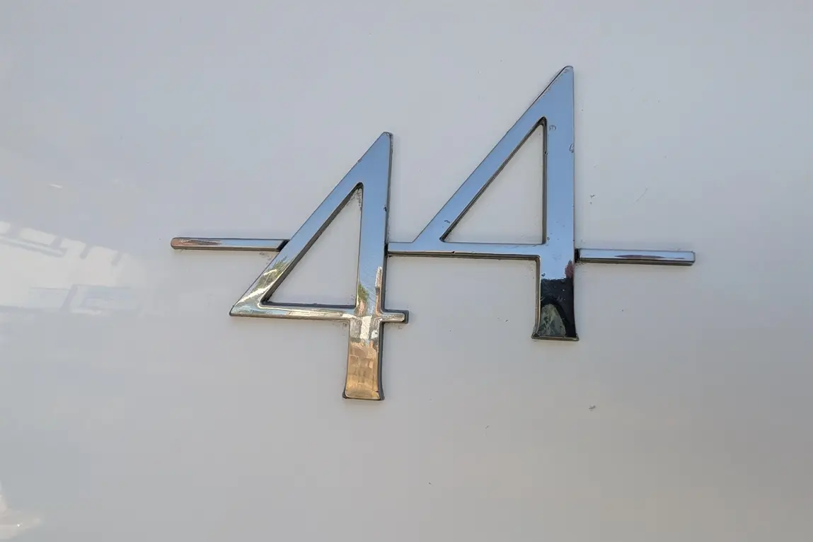 Shiny chrome number "44" displayed on a white background, featuring modern typography and a sleek design.