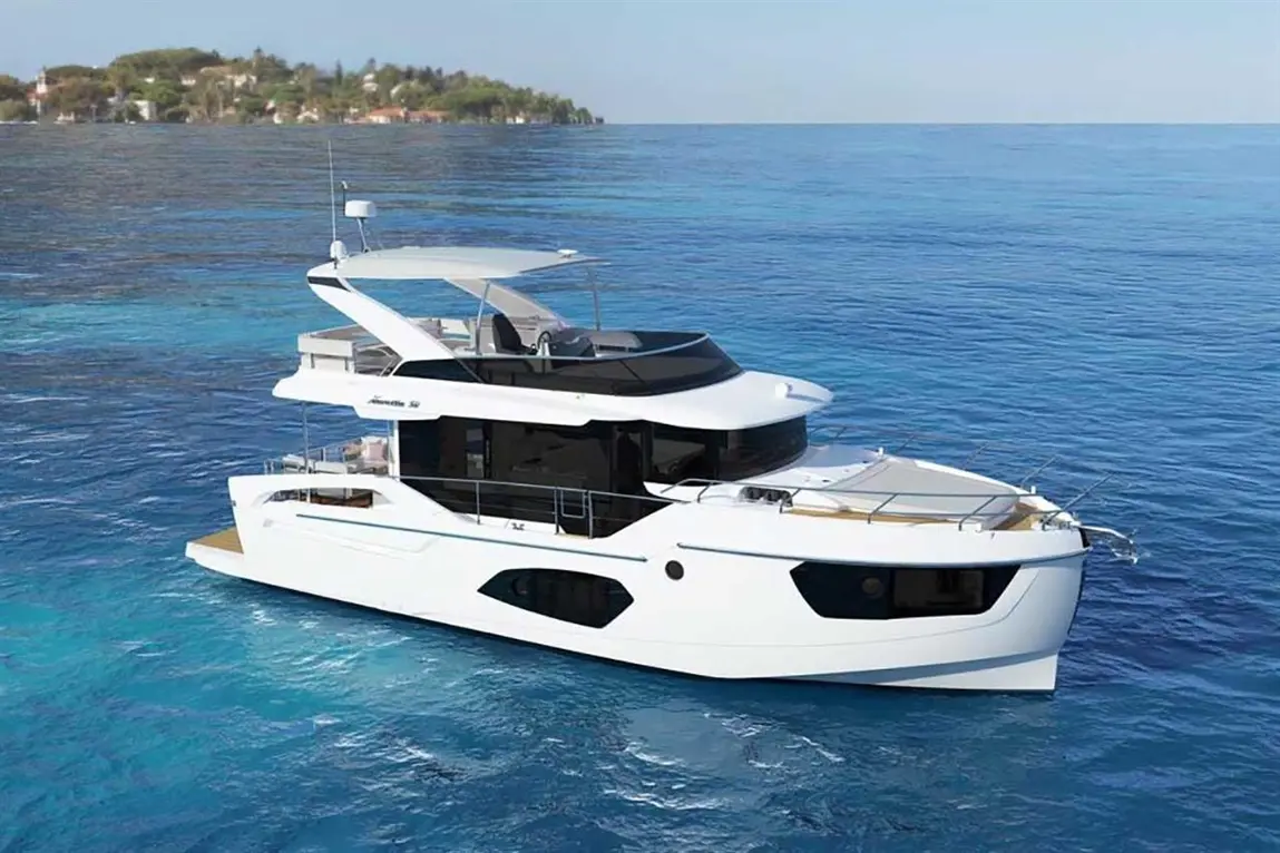 Luxury motor yacht cruising in clear blue waters, with a modern design and a scenic hillside in the background.