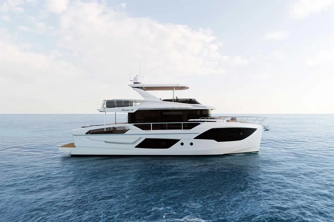 Luxury yacht Navetta 42 sailing on calm waters, showcasing a sleek white and black design against a clear sky.
