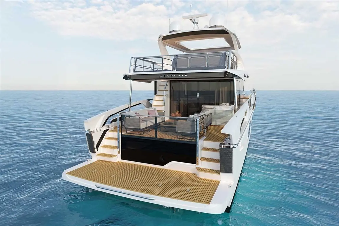 Luxury yacht docked at sea, featuring a spacious deck, seating area, and panoramic views under a clear sky.