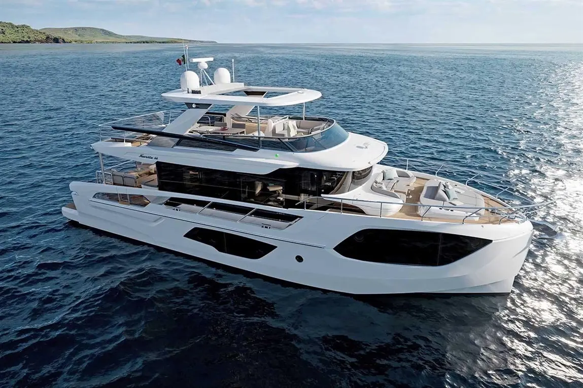A luxury yacht named "Maritima 44" navigates calm waters, showcasing sleek design and spacious outdoor seating areas.
