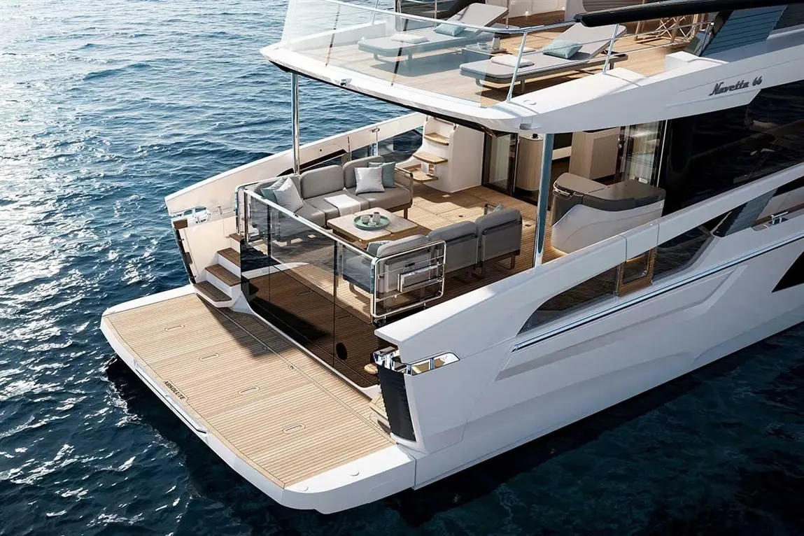 Luxury yacht deck featuring seating, tables, and a stunning ocean view, showcasing modern design and elegance.