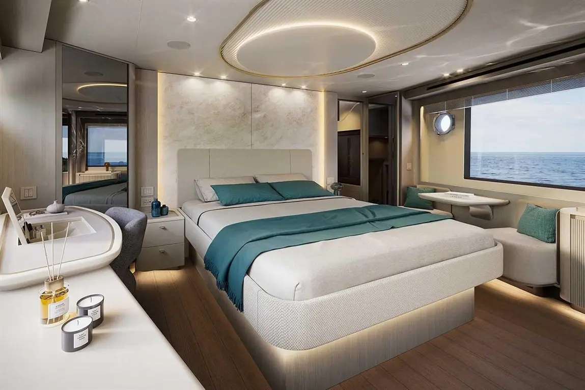 Modern luxury cabin featuring a double bed, stylish decor, a window with sea view, and a workspace with candles.