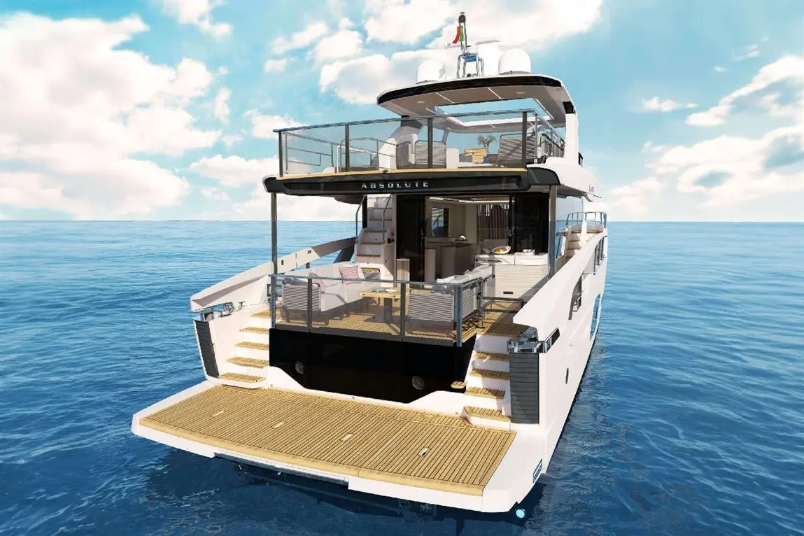 Luxury yacht 'Absolute' with outdoor seating, overlooking calm waters and a blue sky, showcasing modern design and elegance.