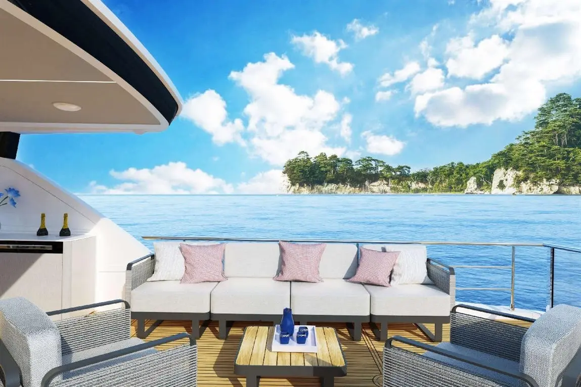 Luxurious yacht deck with modern seating, ocean view, and blue sky, featuring a table with decorative items and drinks.