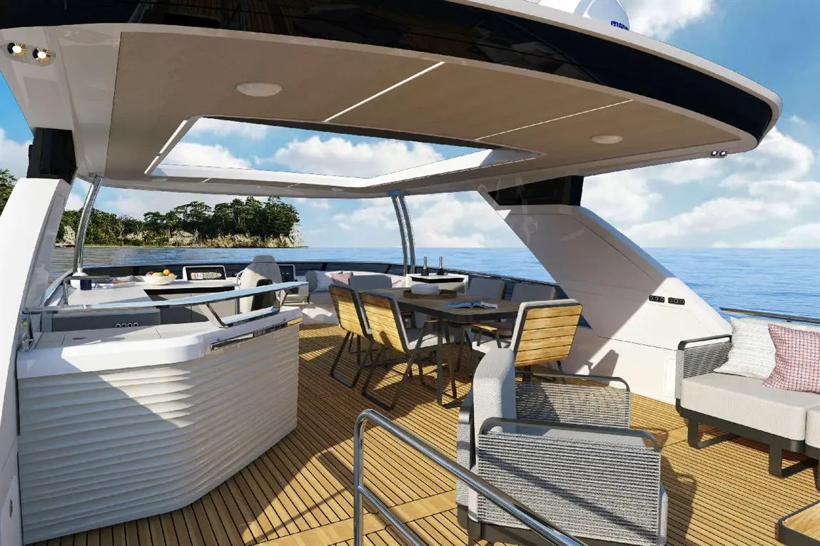 Luxury yacht interior with modern seating, dining area, and a view of the tranquil sea and landscape on the horizon.