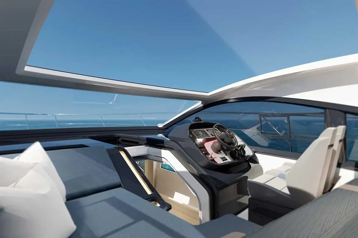 Modern yacht interior featuring a sleek steering console, comfortable seating, and panoramic views of the sea.