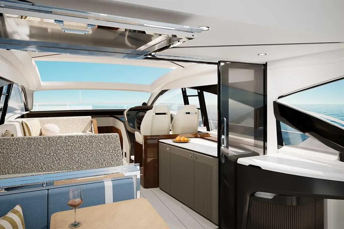 Luxurious yacht interior featuring a dining area, modern kitchen, and panoramic windows overlooking the sea.