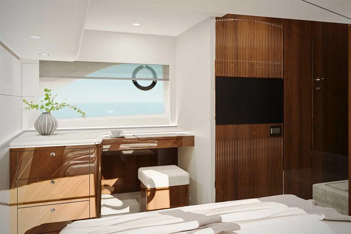 Modern yacht interior featuring a stylish desk, plush stool, and large window with sea views, accented by wooden textures.