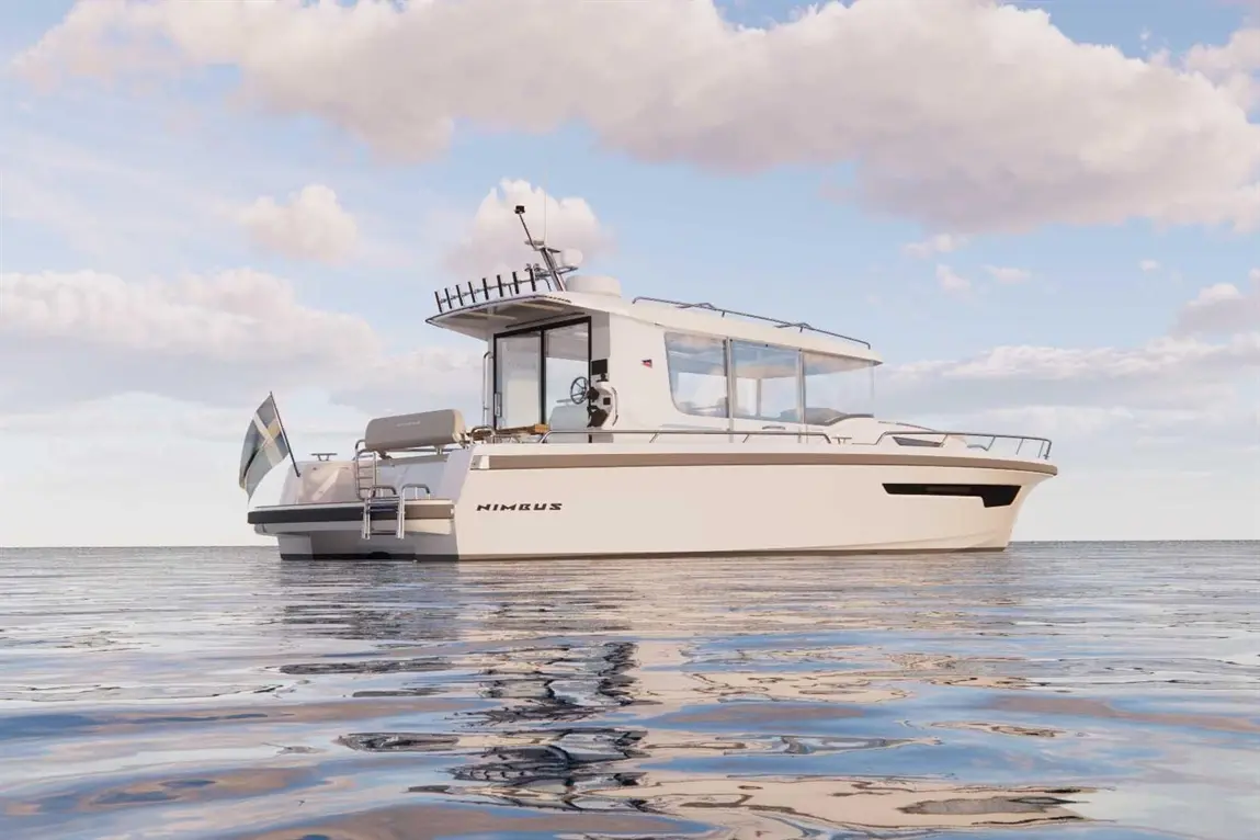 A Nimbus boat is anchored on calm water under a blue sky with clouds, showcasing its sleek design and modern features.