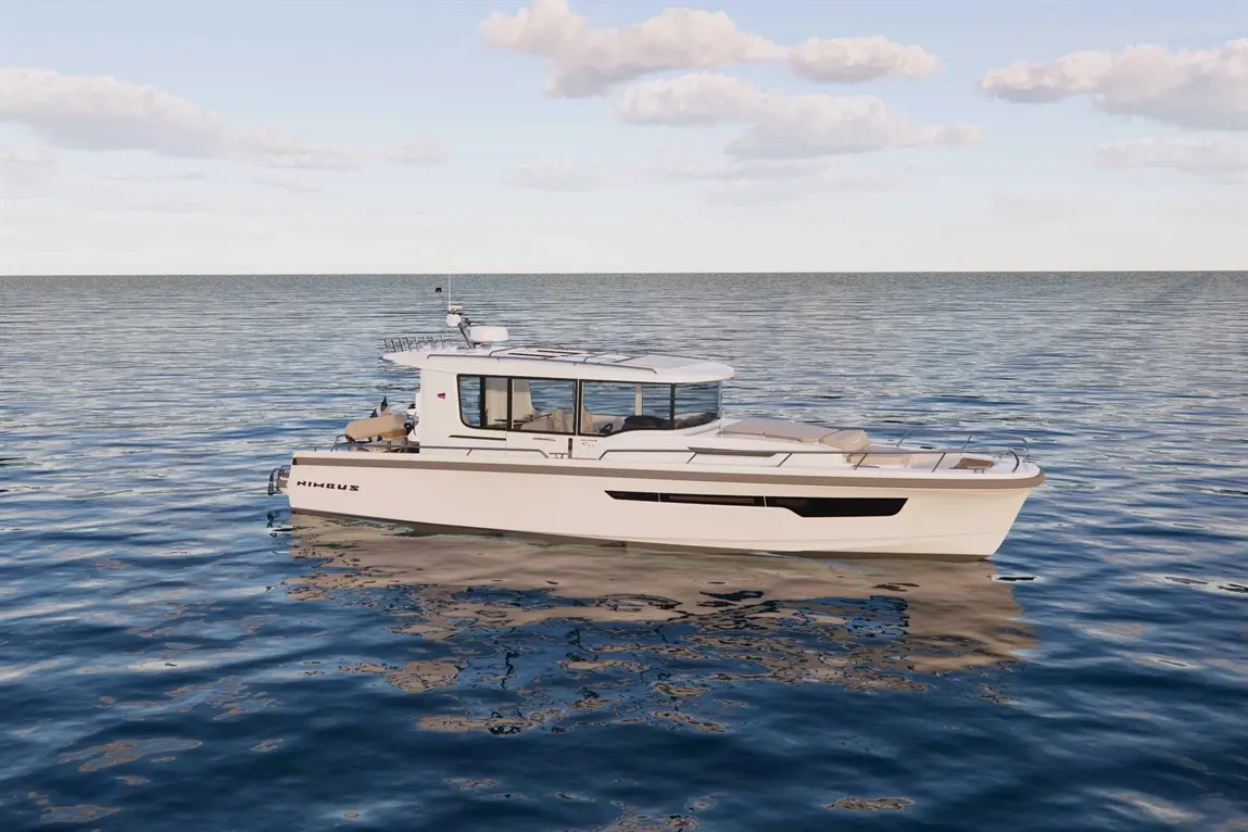 A modern boat labeled "Nimbus" floats on calm waters under a clear sky with scattered clouds, showcasing sleek design.