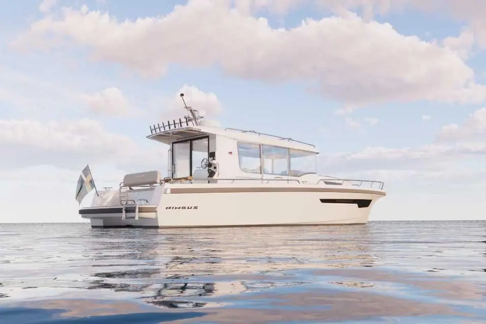 A sleek white Nimbus boat floating on calm waters under a blue sky with fluffy clouds, showcasing modern design features.