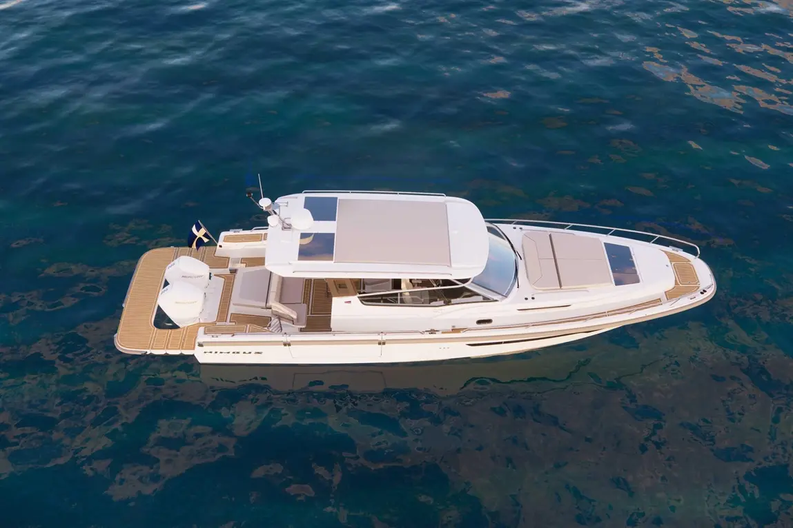 A luxury motorboat named 'Minu' glides over clear blue water, showcasing its sleek design and spacious deck.