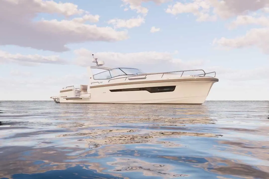 A sleek white motorboat gently floats on calm waters under a blue sky with scattered clouds.