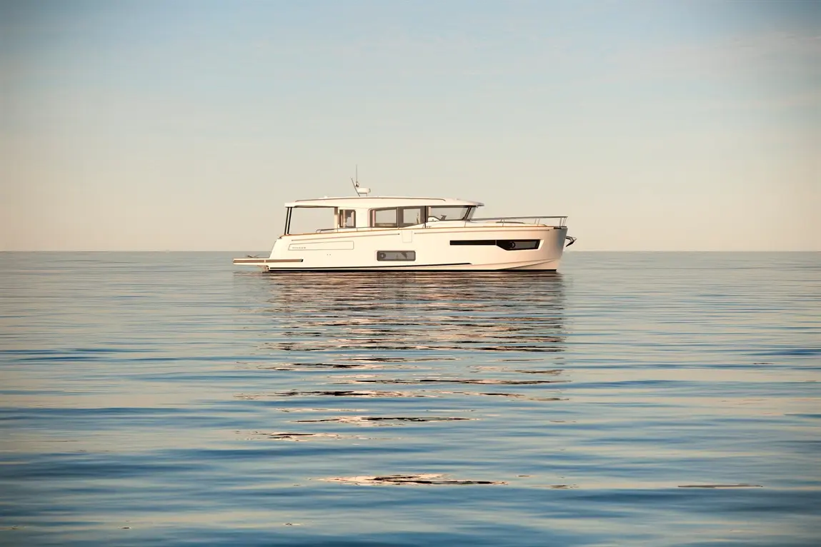 A sleek white boat gently floats on calm water, reflecting the serene blue sky and creating a tranquil scene.