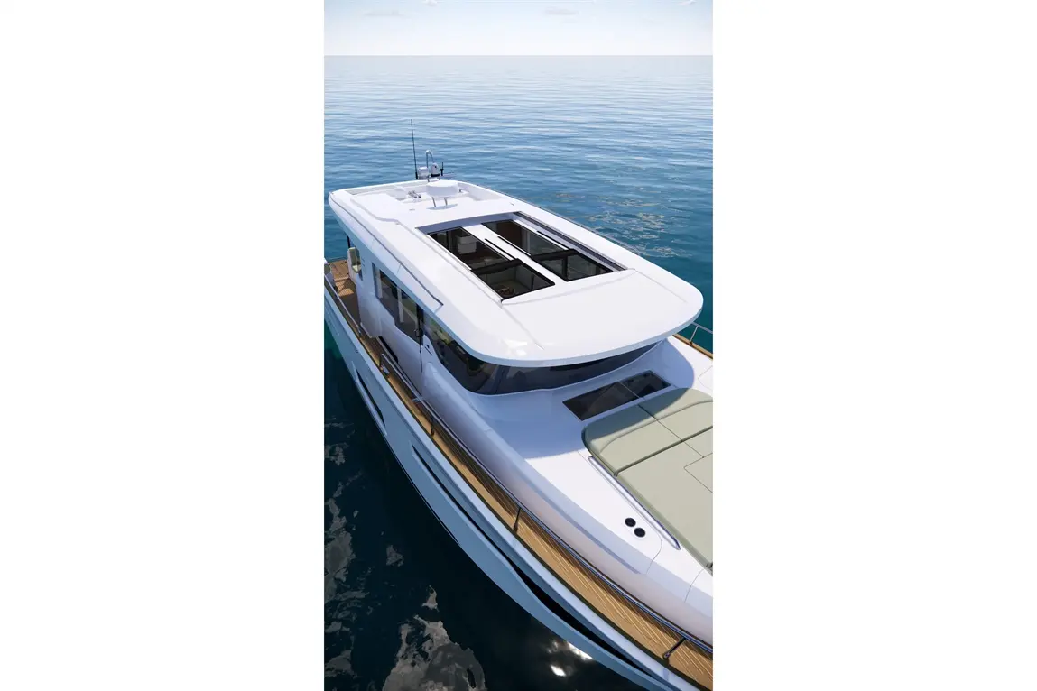 Luxury motor yacht with a sleek white design, panoramic windows, and a spacious deck on calm blue waters under a clear sky.