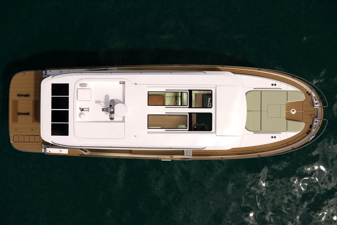 Top view of a modern yacht featuring a spacious deck, helm, and seating area, set against a dark water background.