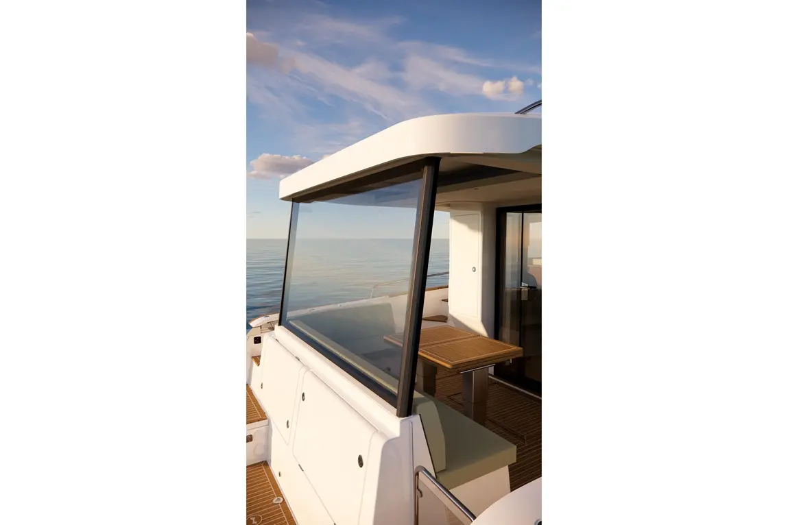 Modern boat interior with a glass partition, seating area, and wooden table, overlooking calm sea and blue sky.
