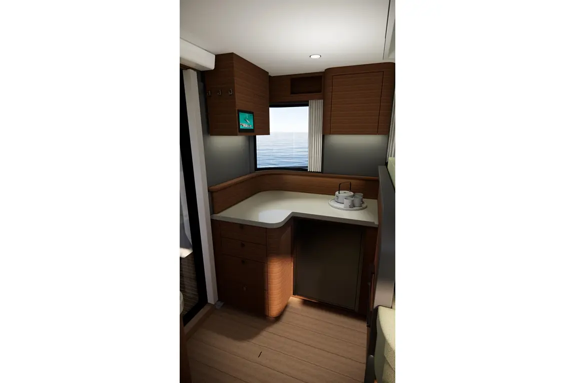 Interior of a boat kitchen featuring a curved countertop, storage units, and a window with sea views, highlighting modern design.