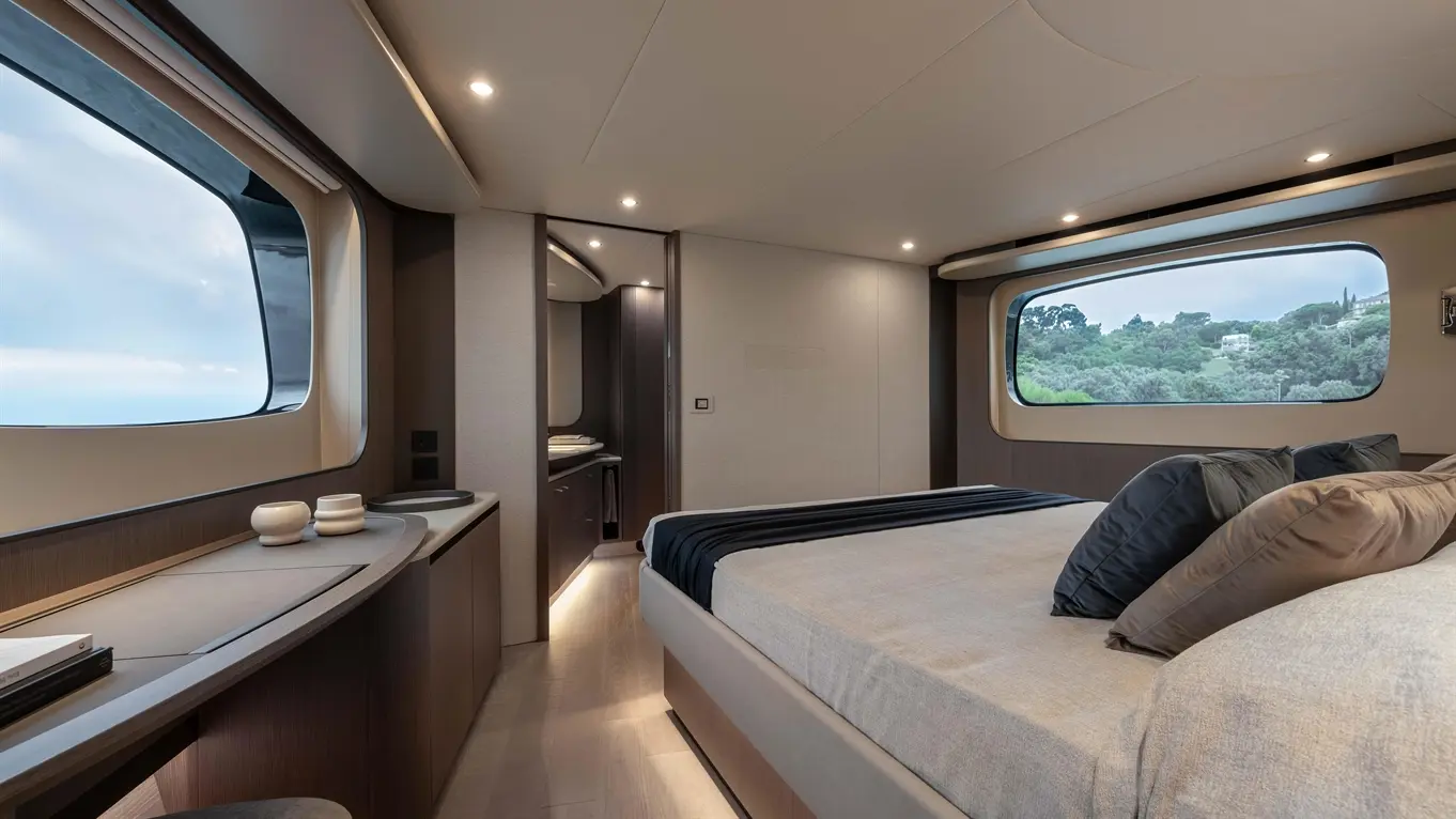 Modern cabin interior with a large window, double bed, and stylish furniture, featuring neutral tones and elegant design.