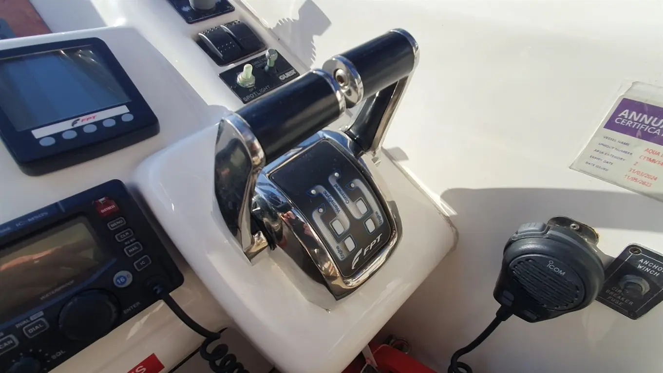 Boat control panel featuring throttle, electronic displays, and an annual certificate labelled "Aqua Liburnum.